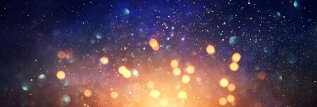 background of abstract glitter lights. blue, gold and black. de focused. bannerの写真素材