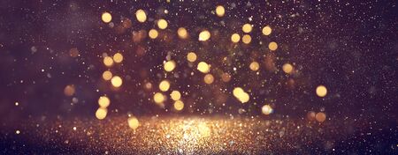 background of abstract glitter lights. gold and black. de focused. bannerの写真素材