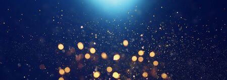 background of abstract glitter lights. blue, gold and black. de focused. bannerの写真素材