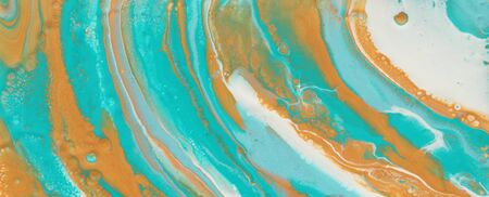 photography of abstract marbleized effect background. turquoise, gold, blue and white creative colors. Beautiful paint. bannerの写真素材
