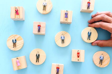 business concept image of people figures over wooden table, human resources and management concept