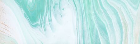 photography of abstract marbleized effect background. turquoise, gold, blue and white creative colors. Beautiful paint. bannerの写真素材