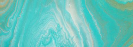 photography of abstract marbleized effect background. turquoise, gold, blue and white creative colors. Beautiful paint. bannerの写真素材