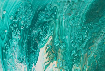 art photography of abstract marbleized effect background. turquoise, emerald green, blue and gold...