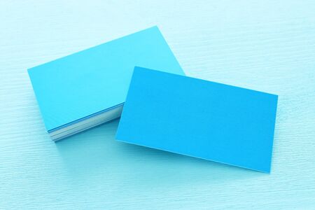 business card over wooden tablestack ofの写真素材