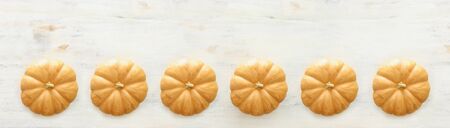 holidays Halloween image. pumpkins over wooden white table. top view, flat lay. banner