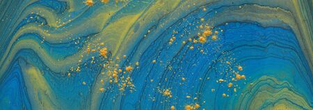 art photography of abstract marbleized effect background. blue and gold creative colors. Beautiful paint.の写真素材