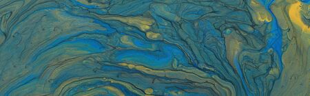 art photography of abstract marbleized effect background. blue and gold creative colors. Beautiful...