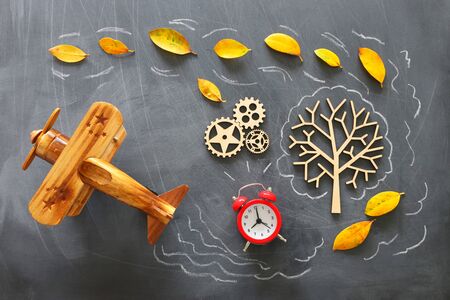 Education concept, banner of vintage airplane on a chalkboard with fall leaves