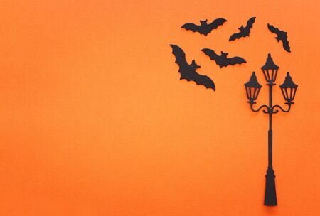 holidays Halloween concept. vintage street lamp and bats over orange background. Top view, flat layの写真素材