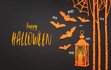holidays concept of Halloween. Orange bats and lantern with candle over black background. Top view, flat layの写真素材