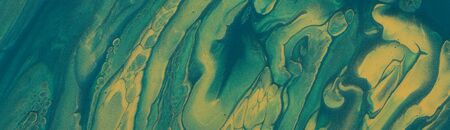 art photography of abstract marbleized effect background. emerald, green and gold creative colors....