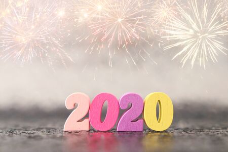 Holiday image of New Year 2020 concept. Wooden number and sparkling background