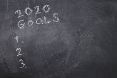 Business concept, top view of blackboard with the phrase 2020 goals