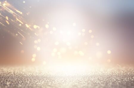 abstract background of glitter vintage lights . silver, gold and white. de-focused