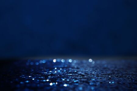 glitter classic blue lights background. de-focused. color of the year 2020