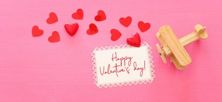 Valentines day concept. red hearts over wooden pink background. Flat lay compositionの写真素材
