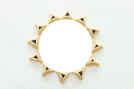 Purim celebration concept (jewish carnival holiday). Hamantaschen cookies over white wooden backgroundの写真素材