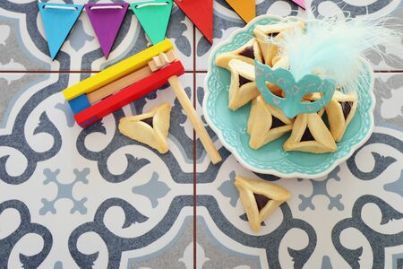 Purim celebration concept (jewish carnival holiday) over blue vintage background. Top view, Flat layの写真素材