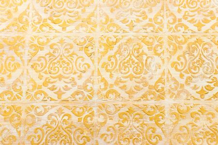 background of royal gold wooden vintage background with floral emboss detailsの写真素材
