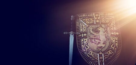 photo of shield knight armor and sword over dark background. Medieval period conceptの写真素材