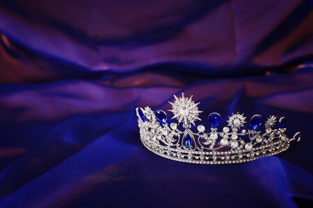 Vintage crown over dark royal purple delicate silk. fantasy medieval periodの写真素材