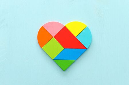 Heart puzzle on blue pastel wooden backgroundの写真素材
