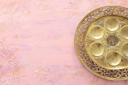 Pesah celebration concept (jewish Passover holiday). Traditional pesah plate text in hebrew: Passover, horseradish, celery, egg, bone, maror, charosetの写真素材