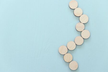 business concept of man hand arranging wooden round blocks. mock up or templateの写真素材