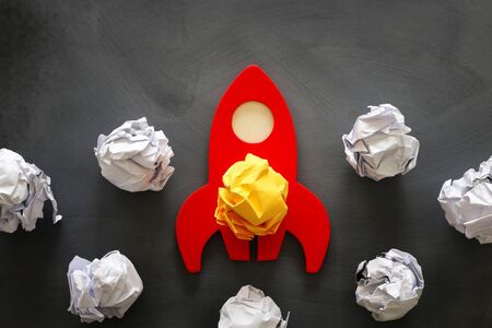 education or innovation concept. Wooden rocket over blackboard background. top viewの写真素材