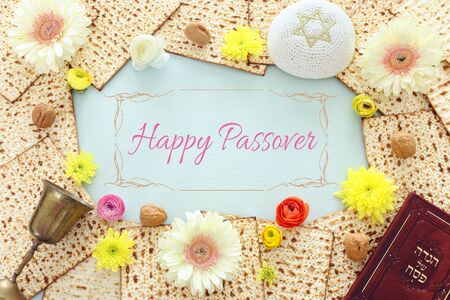 Pesah celebration concept (jewish Passover holiday). Traditional book with text in hebrew: Passover...