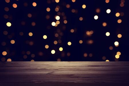 background Image of wooden table in front of abstract blurred restaurant lights