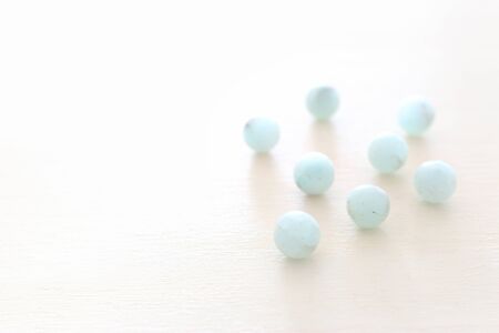 blue amazonite gemstones beads on white wooden backgroundの写真素材
