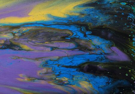 art photography of abstract marbleized effect background. Black, gold, yellow, purple and blue...