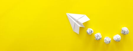 education or innovation concept. paper origami plane over yellow backgroundの写真素材