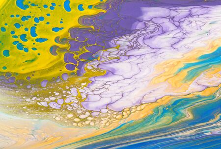 art photography of abstract marbleized effect background. Yellow, gold, blue, purple, pink and white...