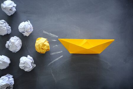 Leadership banner concept with paper boat on blackboard background. One leader ship leads others.の写真素材