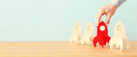 rocket leadership concept. red rocket as leader of the group. idea of standing out of the crowdの写真素材