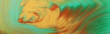 art photography of abstract marbleized effect background. Turquoise, green, gold and blue creative...