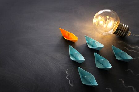 Education concept image. Creative idea and innovation. Light bulb as metaphor over blackboard