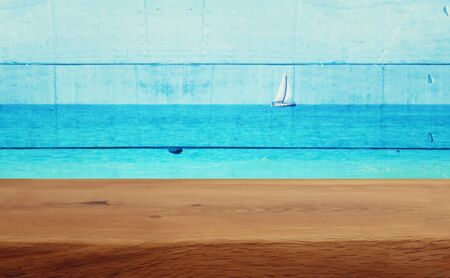 background Image of vintage table in front of old summer tropical decorative wooden wall. ready for product displayの写真素材