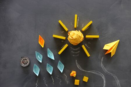 Education concept image. Creative idea and innovation. Crumpled paper as light bulb metaphor over blackboardの写真素材