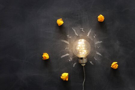 Education concept image. Creative idea and innovation. Light bulb as metaphor over blackboardの写真素材