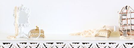 Image of white vintage mirror and pearls over wooden table. For mockup, can be used for photography montageの写真素材