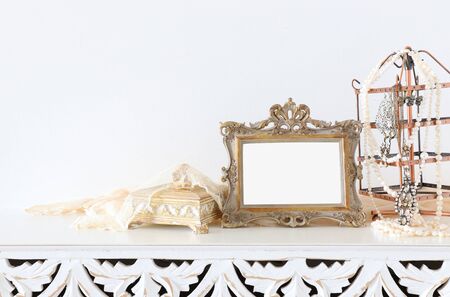 Image of white vintage mirror and pearls over wooden table. For mockup, can be used for photography montageの写真素材