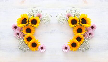 Top view image of sunflowers over white wooden backgroundの写真素材