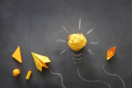 Education concept image. Creative idea and innovation. Crumpled paper as light bulb metaphor over...