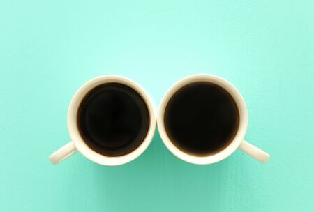 Top view image of two coffe cups on mint pastel background. Flat lay. Copy spaceの写真素材