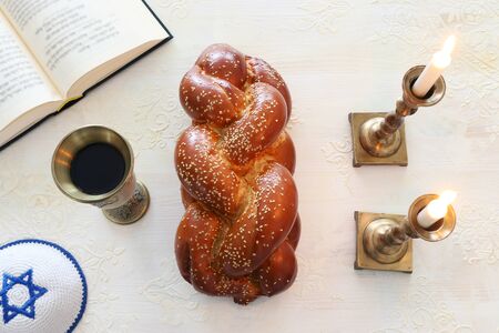 shabbat image. challah bread, shabbat wine and candles. Top view