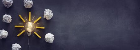 Education concept image. Creative idea and innovation. Light bulb as metaphor over blackboard